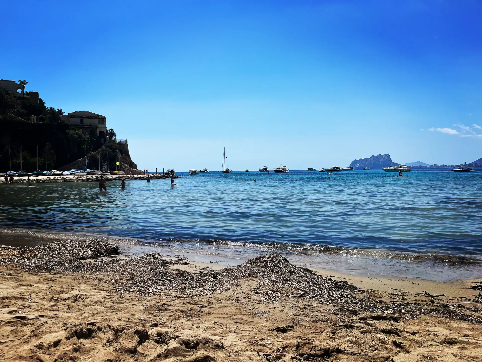 the bay of el portet with boats in the background